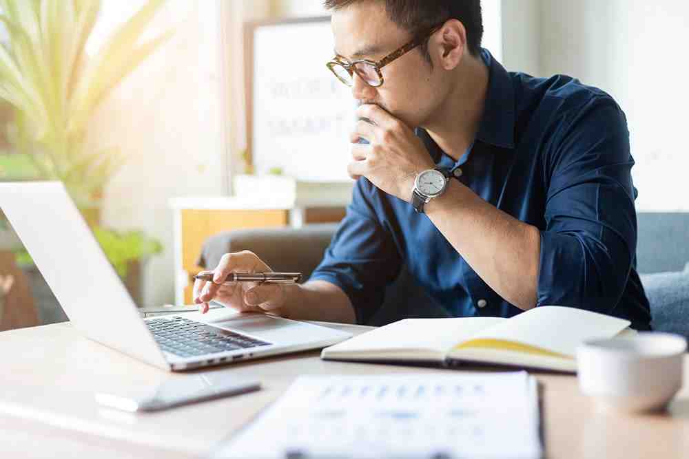 Person on computer reviewing financial documents